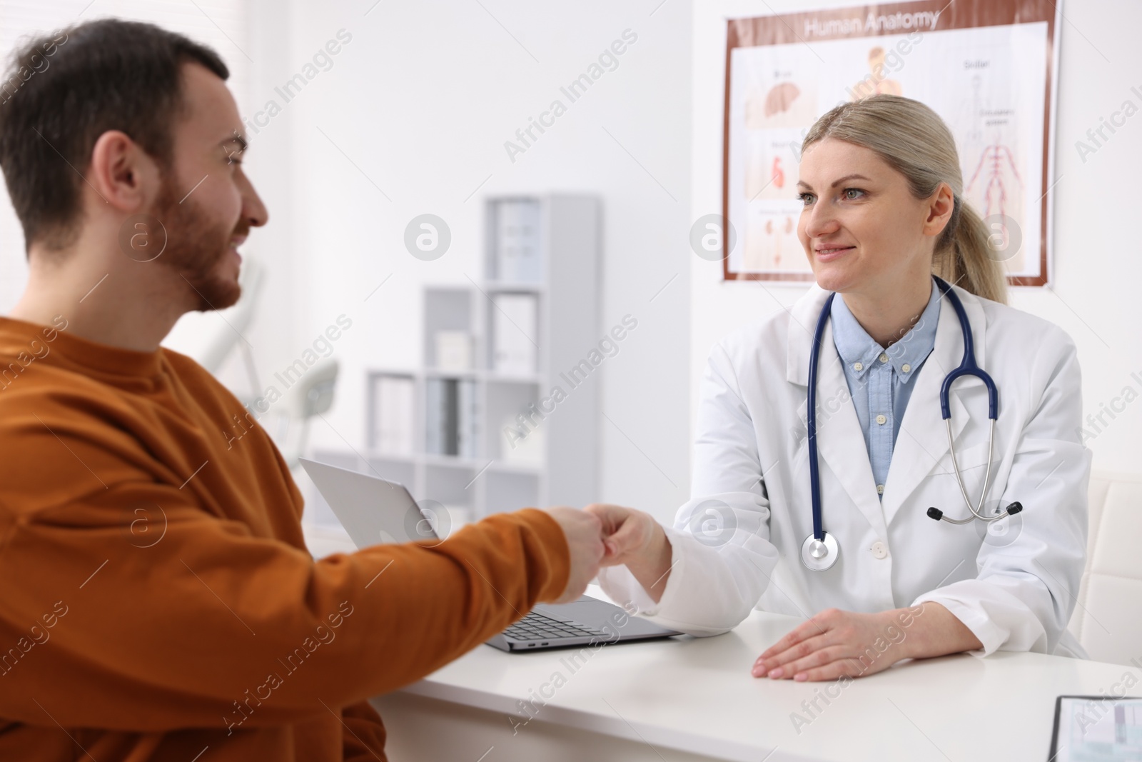 Photo of Doctor and patient shaking hands in hospital