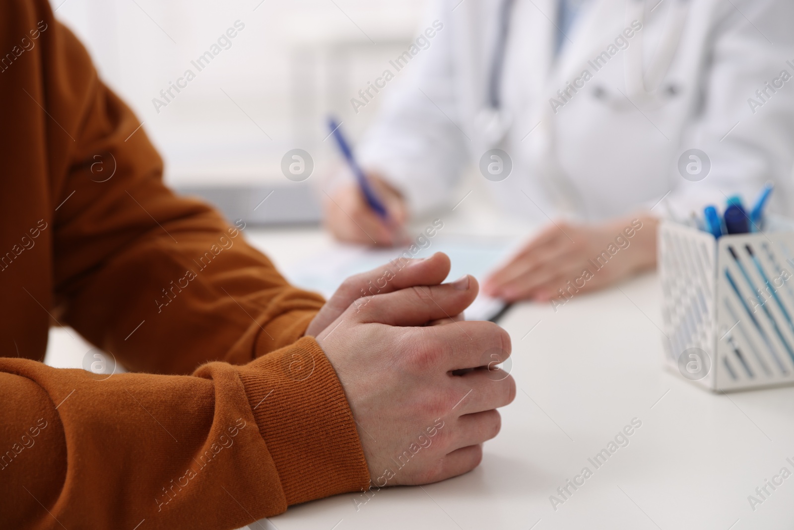 Photo of Man having appointment with doctor in hospital, closeup