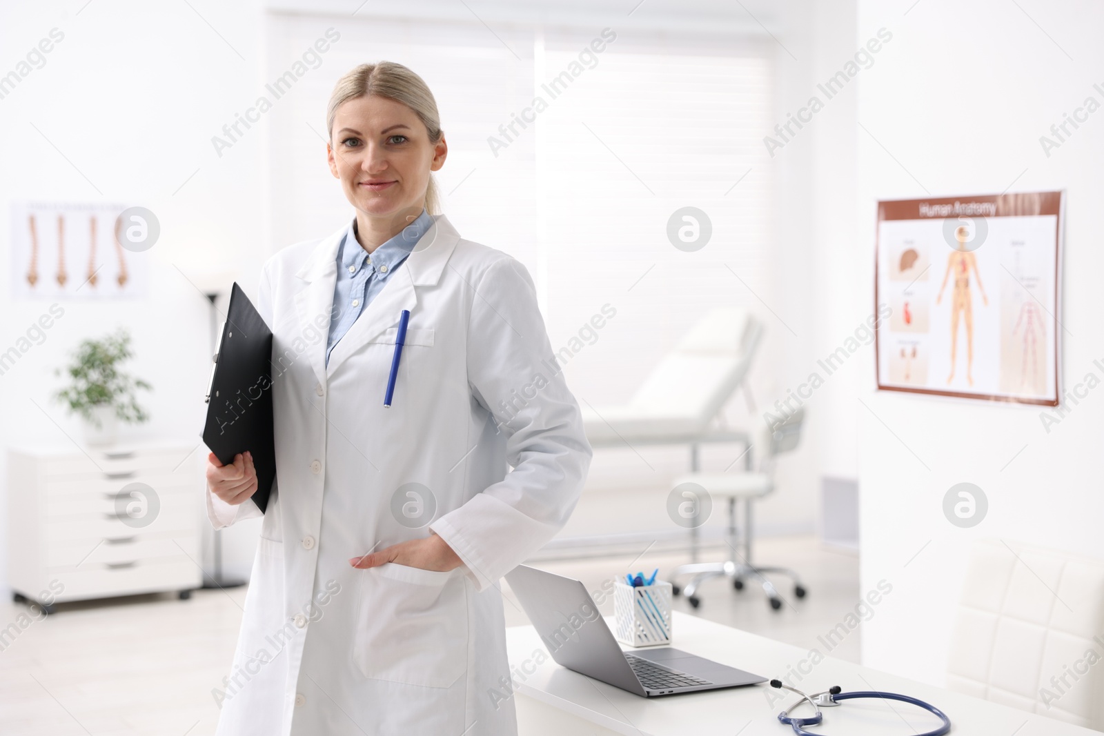 Photo of Portrait of professional doctor with clipboard in hospital. Space for text