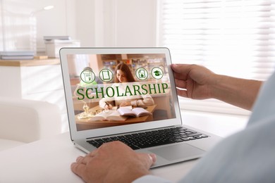 Image of Student searching for scholarships using laptop at home, closeup. Open website on device screen