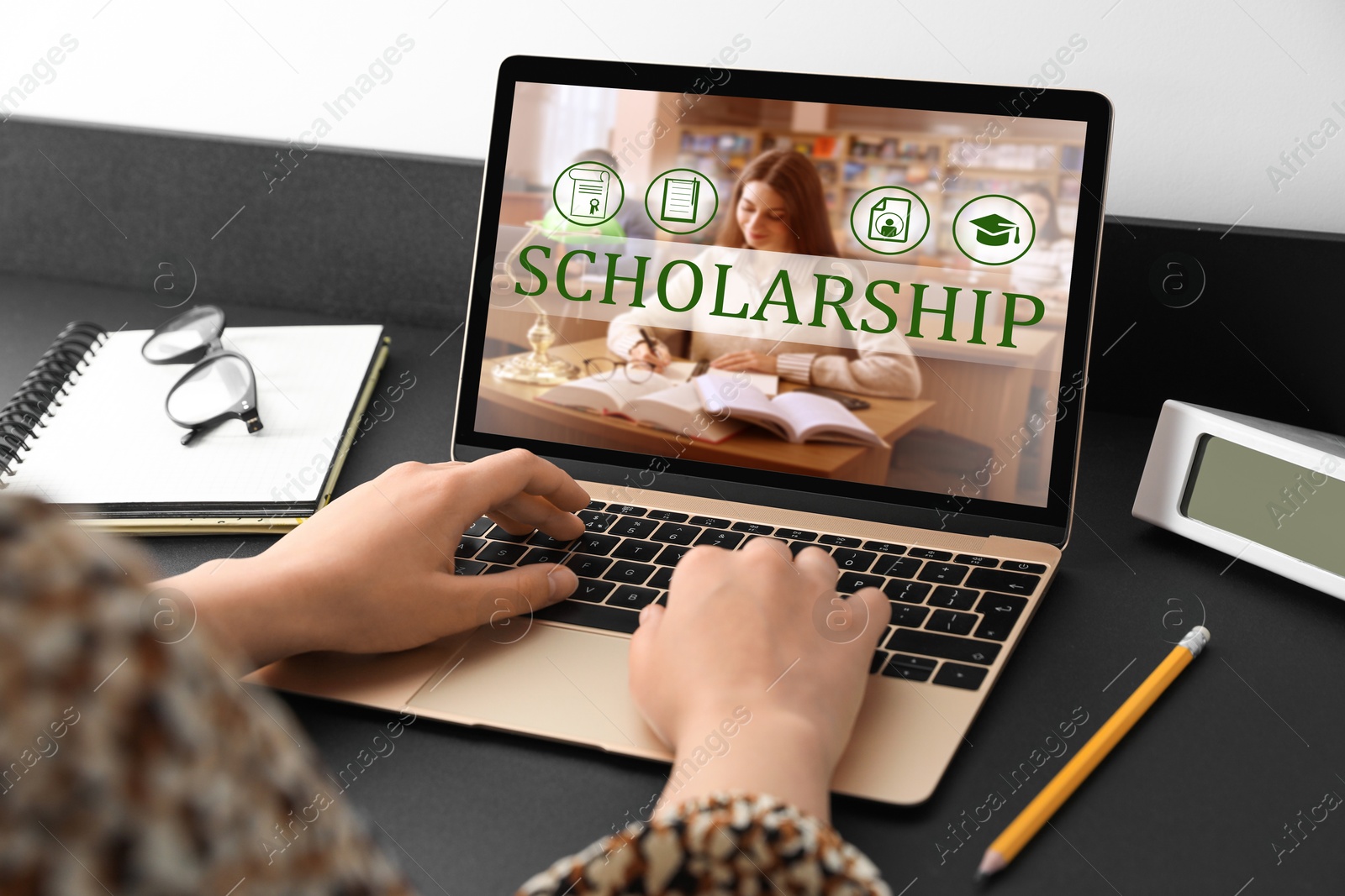 Image of Student searching for scholarships using laptop at home, closeup. Open website on device screen