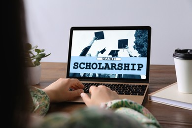 Image of Student searching for scholarships using laptop at home, closeup. Open website on device screen