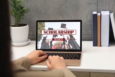 Image of Student searching for scholarships using laptop at home, closeup. Open website on device screen