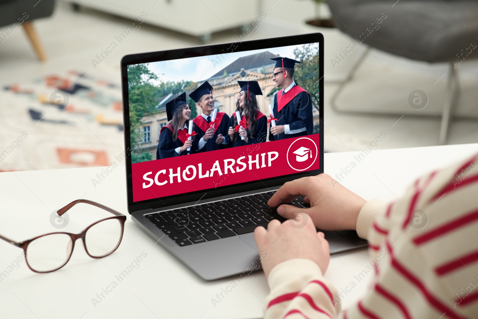 Image of Student searching for scholarships using laptop at home, closeup. Open website on device screen