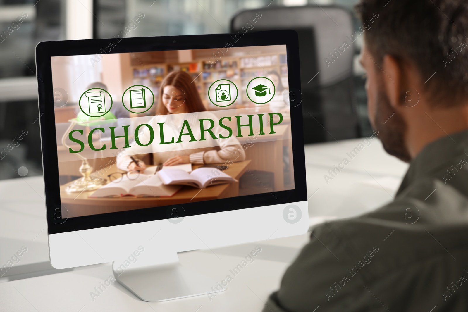 Image of Student searching for scholarships using computer at home. Open website on display