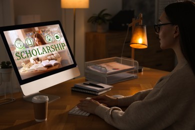 Image of Student searching for scholarships using computer at home. Open website on display