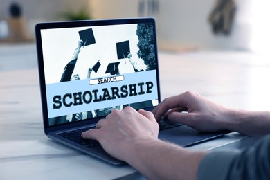 Image of Student searching scholarships using laptop at home, closeup. Open website on device screen