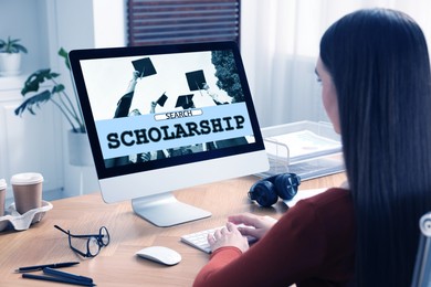 Image of Student searching for scholarships using computer at home. Open website on display