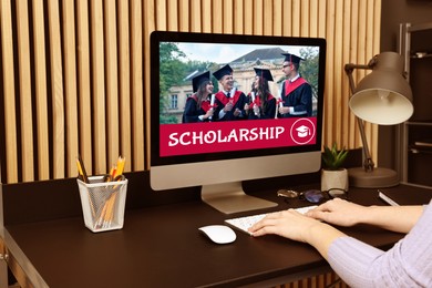 Image of Student searching for scholarships using computer at home, closeup. Open website on display