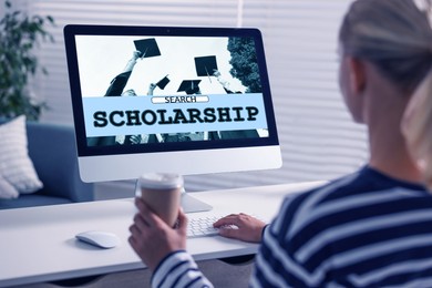 Image of Student searching for scholarships using computer at home. Open website on display