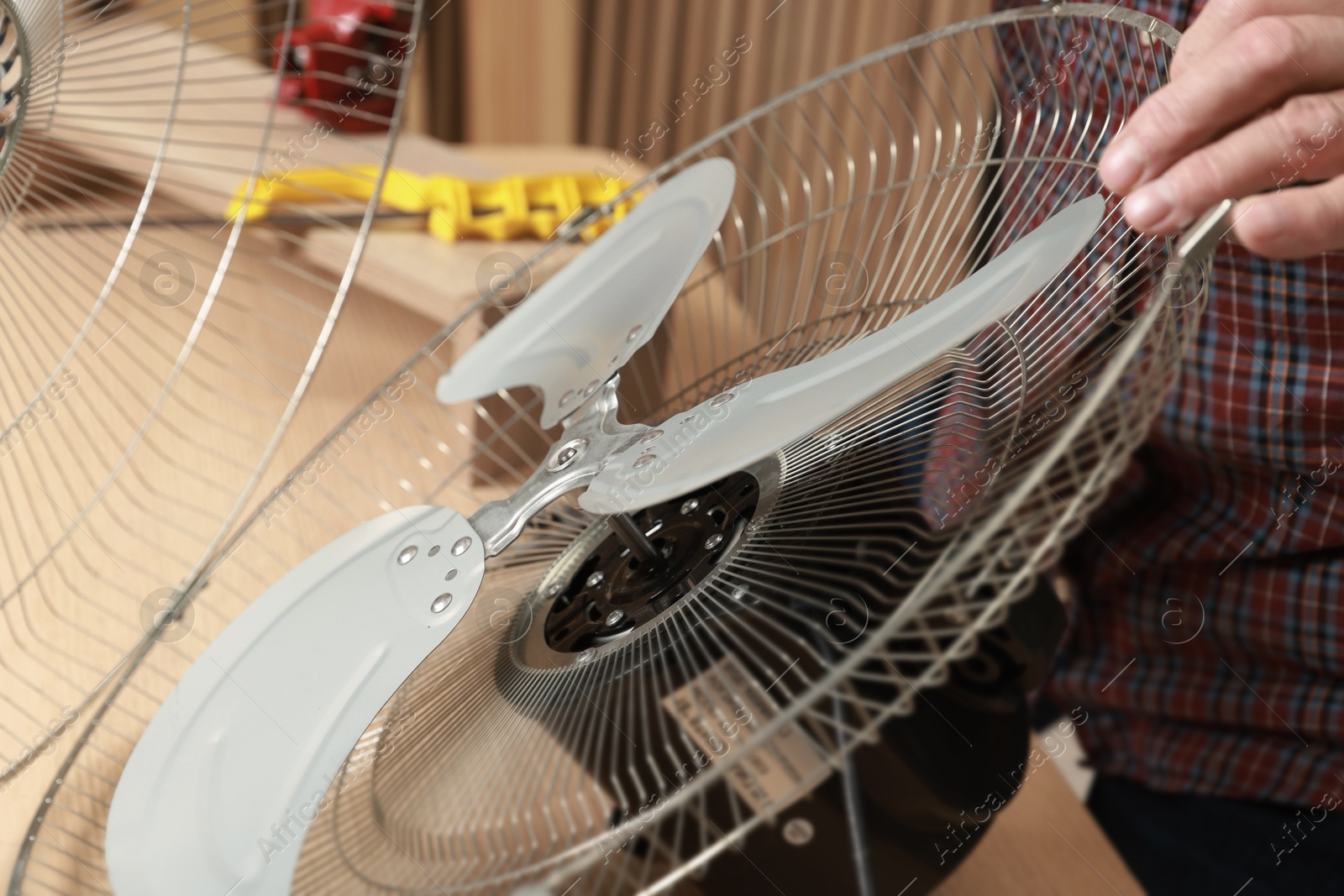 Photo of Relaxing hobby. Senior man repairing fan in workshop, closeup