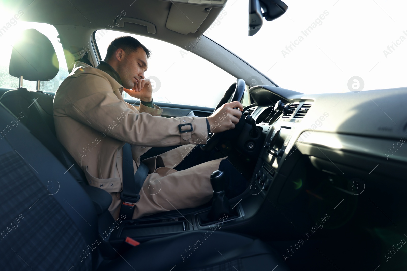 Photo of Tired driver sleeping in his modern car