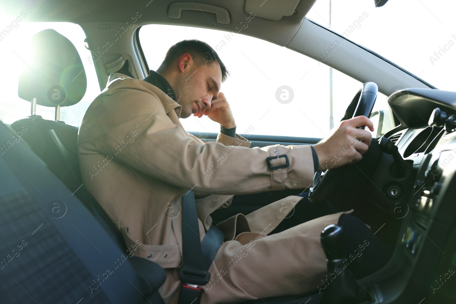 Photo of Tired driver sleeping in his modern car