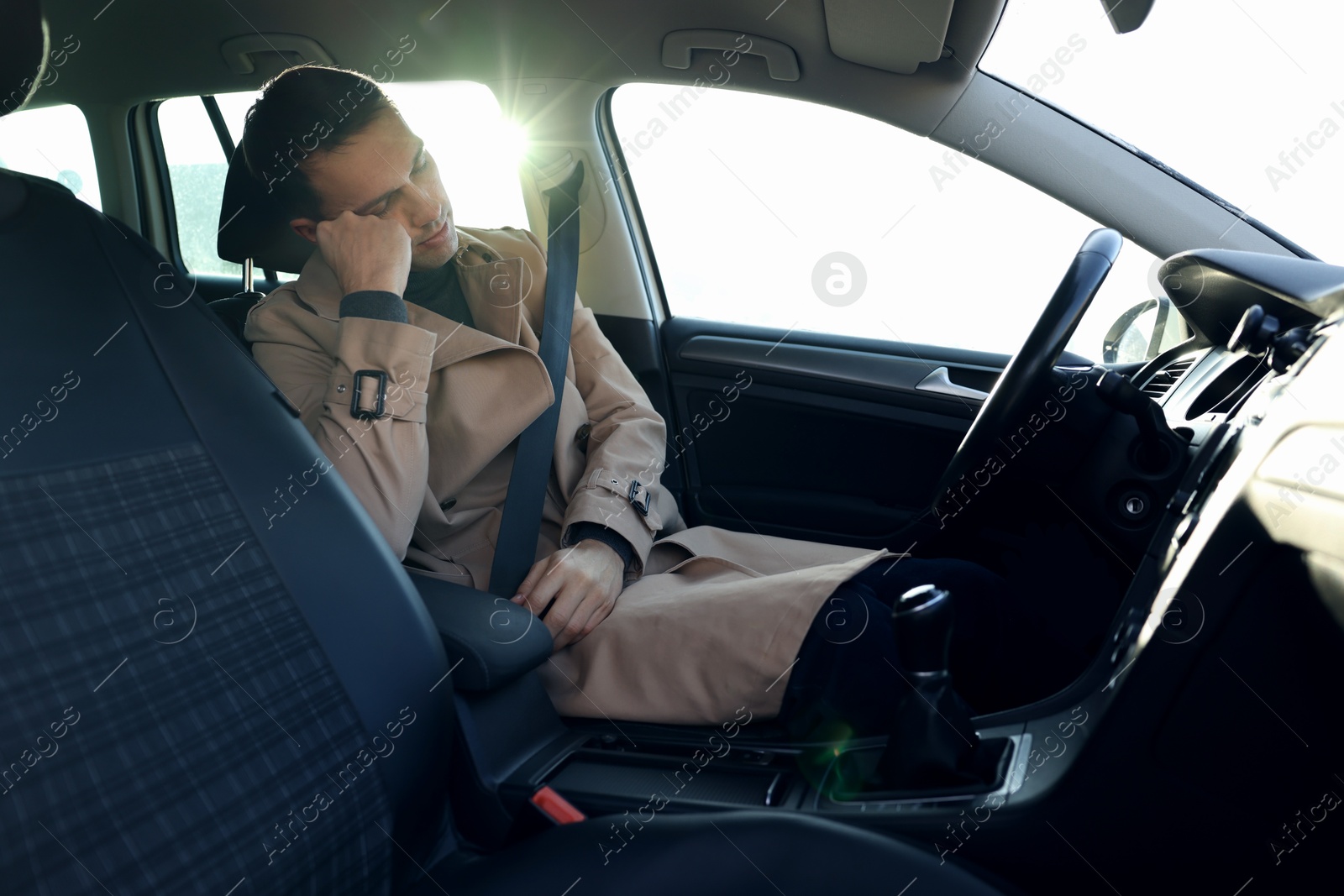 Photo of Tired driver sleeping in his modern car