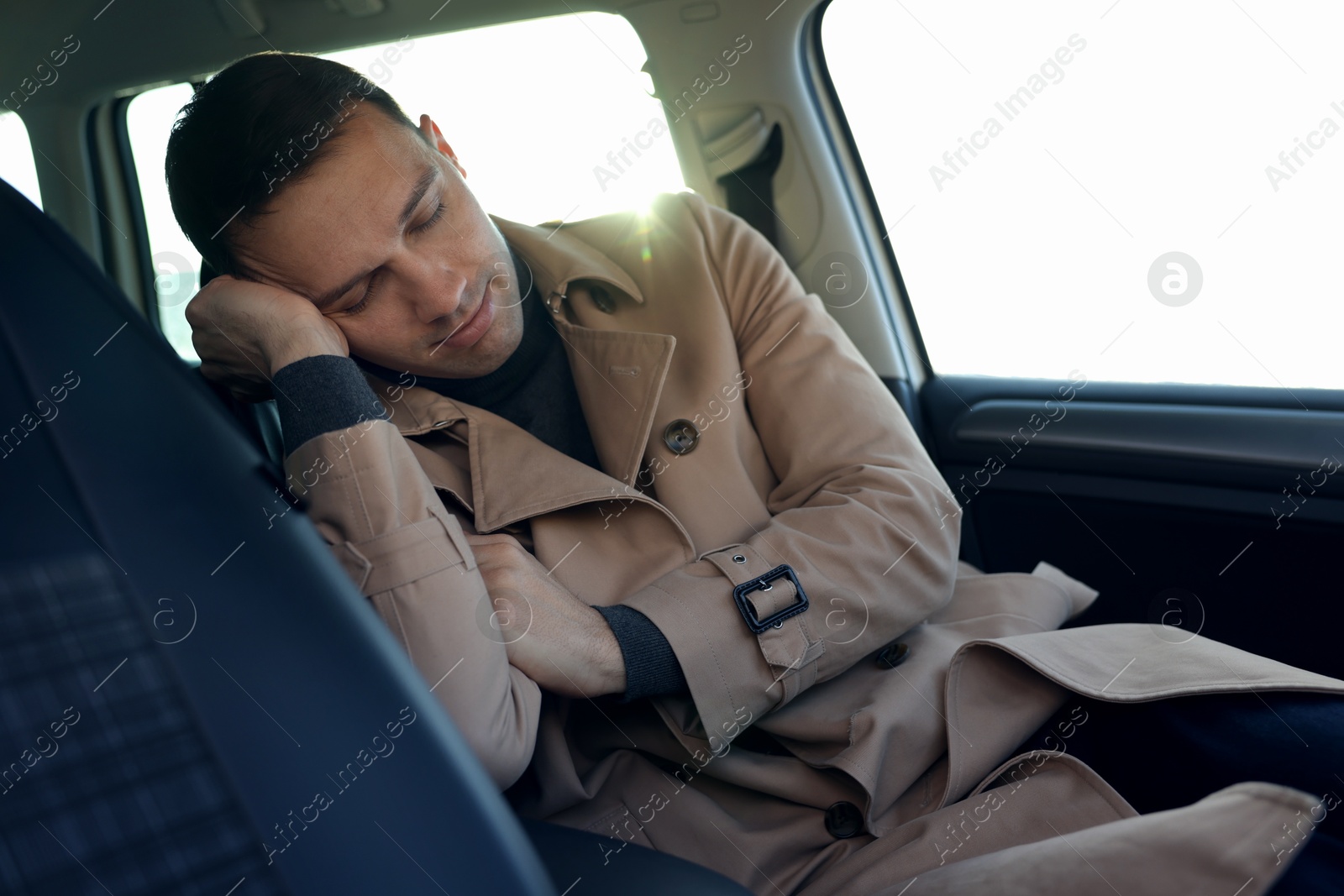 Photo of Tired driver sleeping in his modern car