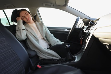 Photo of Tired driver sleeping in her modern car