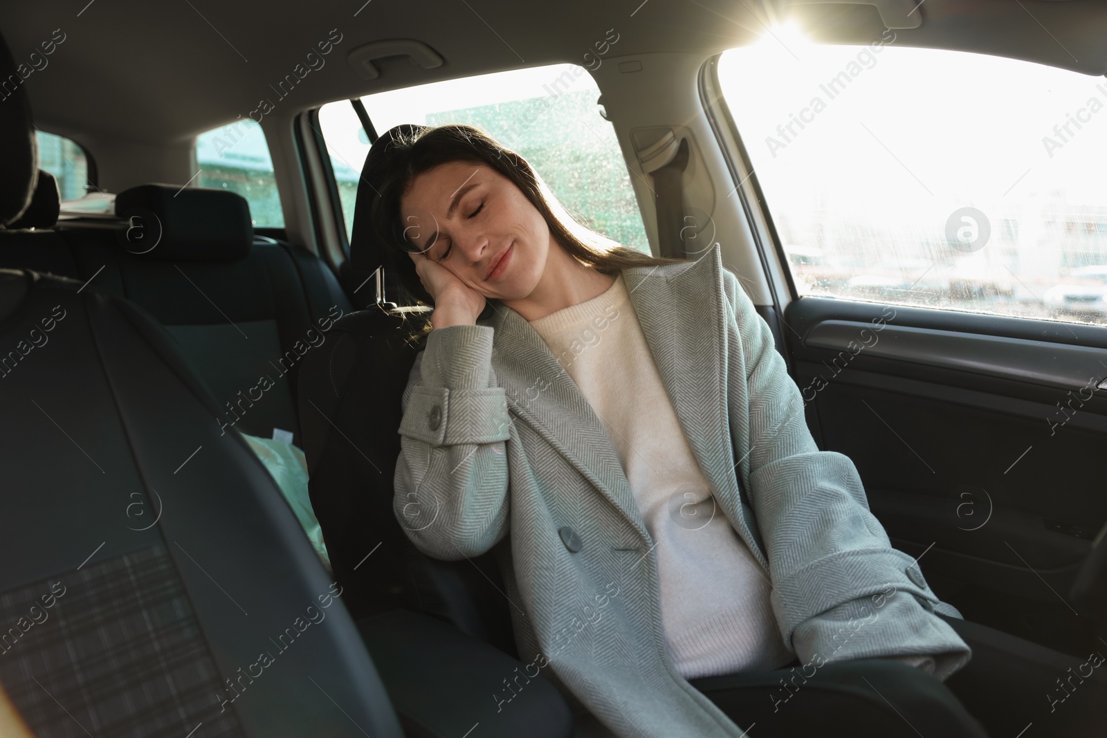 Photo of Tired driver sleeping in her modern car