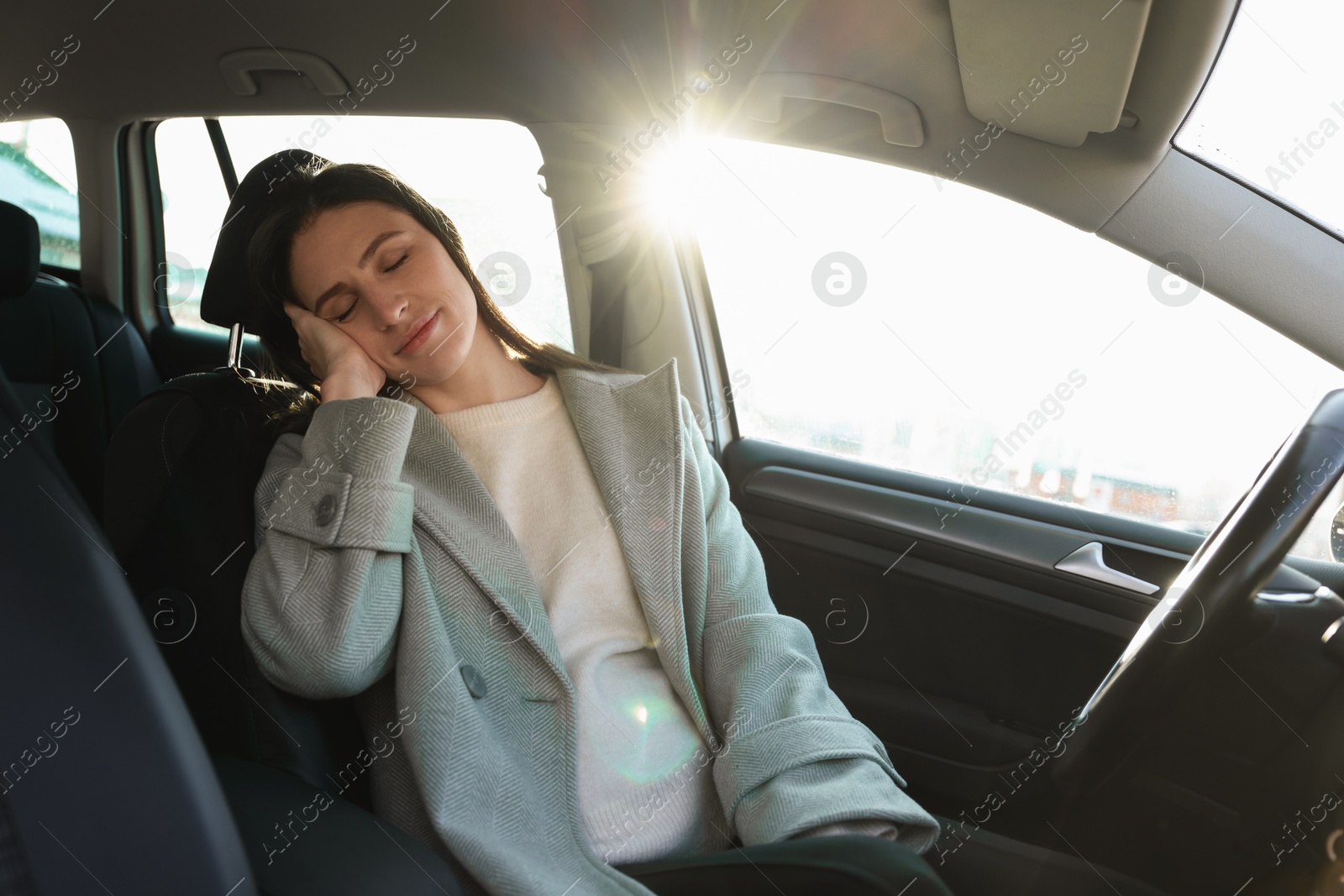 Photo of Tired driver sleeping in her modern car