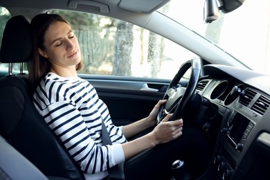 Photo of Tired driver sleeping in her modern car