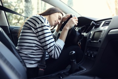 Photo of Tired driver sleeping on steering wheel in car