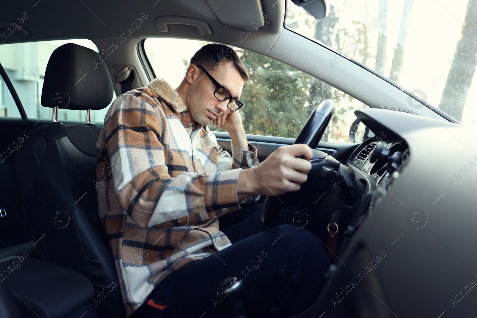 Photo of Tired driver sleeping in his modern car