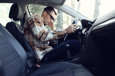 Photo of Tired driver sleeping in his modern car