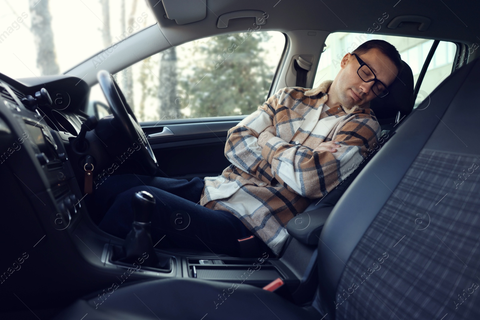 Photo of Tired driver sleeping in his modern car