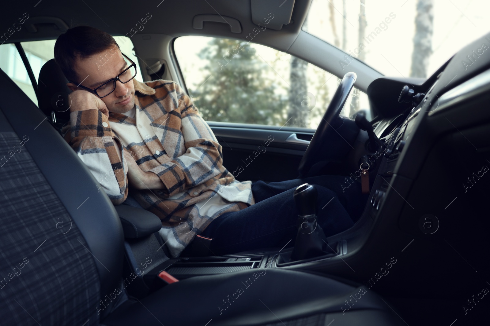 Photo of Tired driver sleeping in his modern car