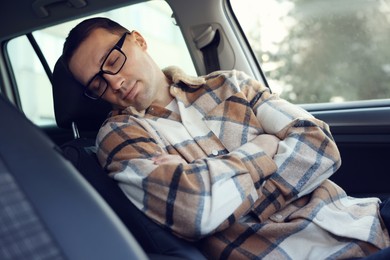 Photo of Tired driver sleeping in his modern car