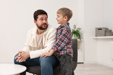 Overwhelmed father and his son at home