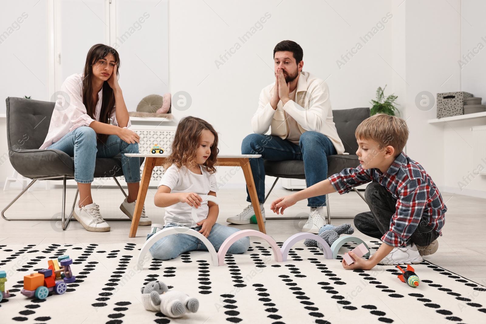 Photo of Hyperactive children playing and their overwhelmed parents at home