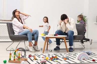 Photo of Hyperactive children playing and their overwhelmed parents at home