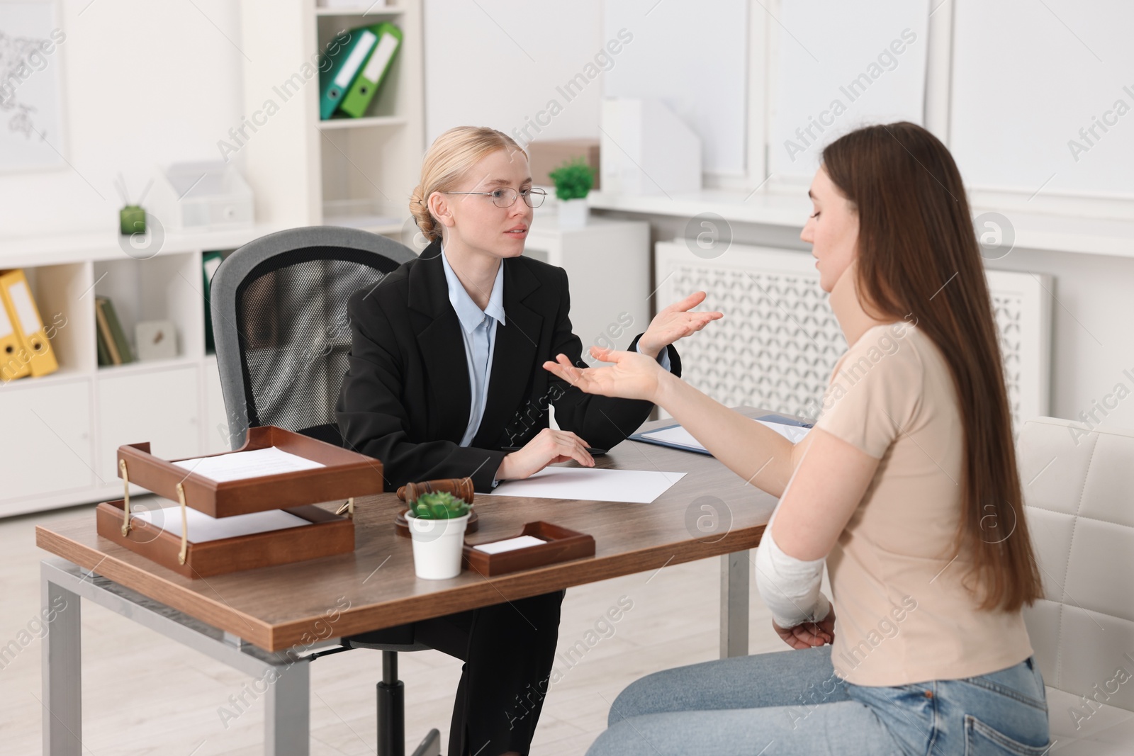 Photo of Injured woman having meeting with lawyer in office