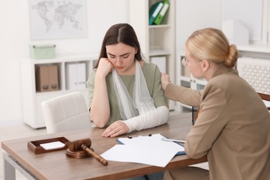 Photo of Injured woman having meeting with lawyer in office