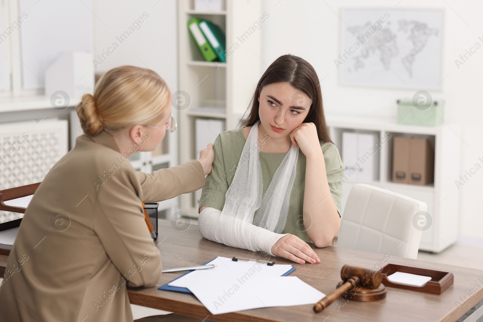 Photo of Injured woman having meeting with lawyer in office