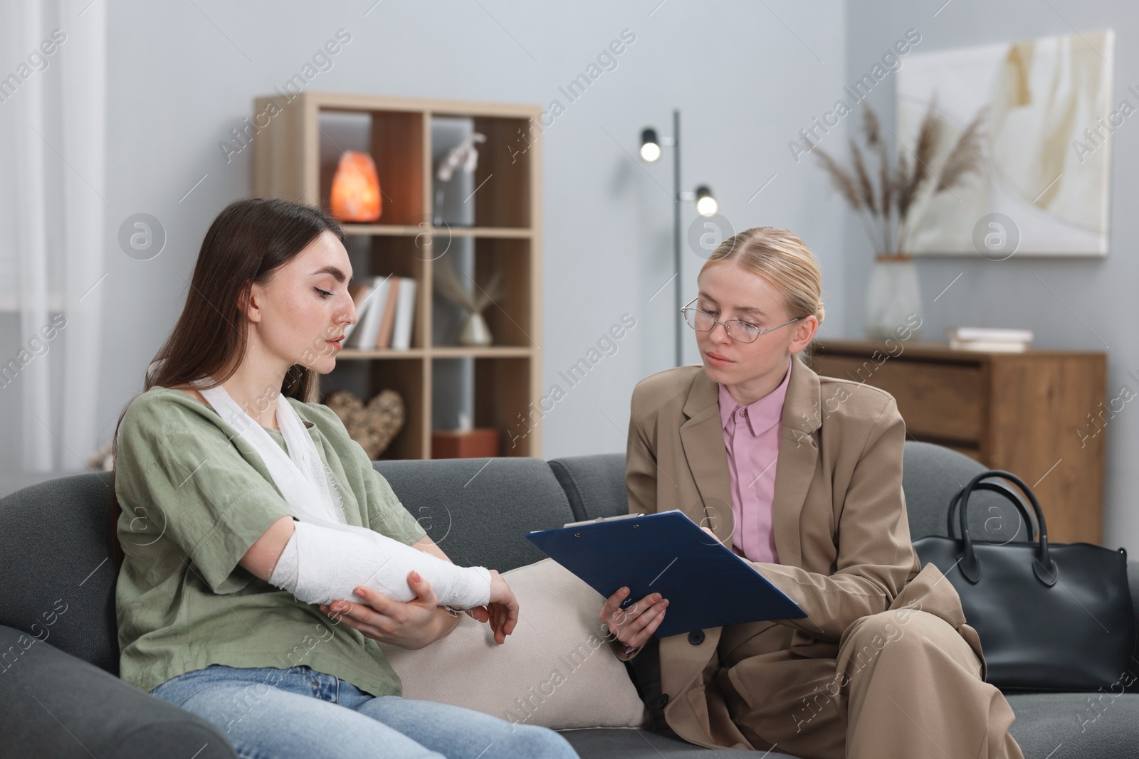 Photo of Injured woman having meeting with lawyer in office