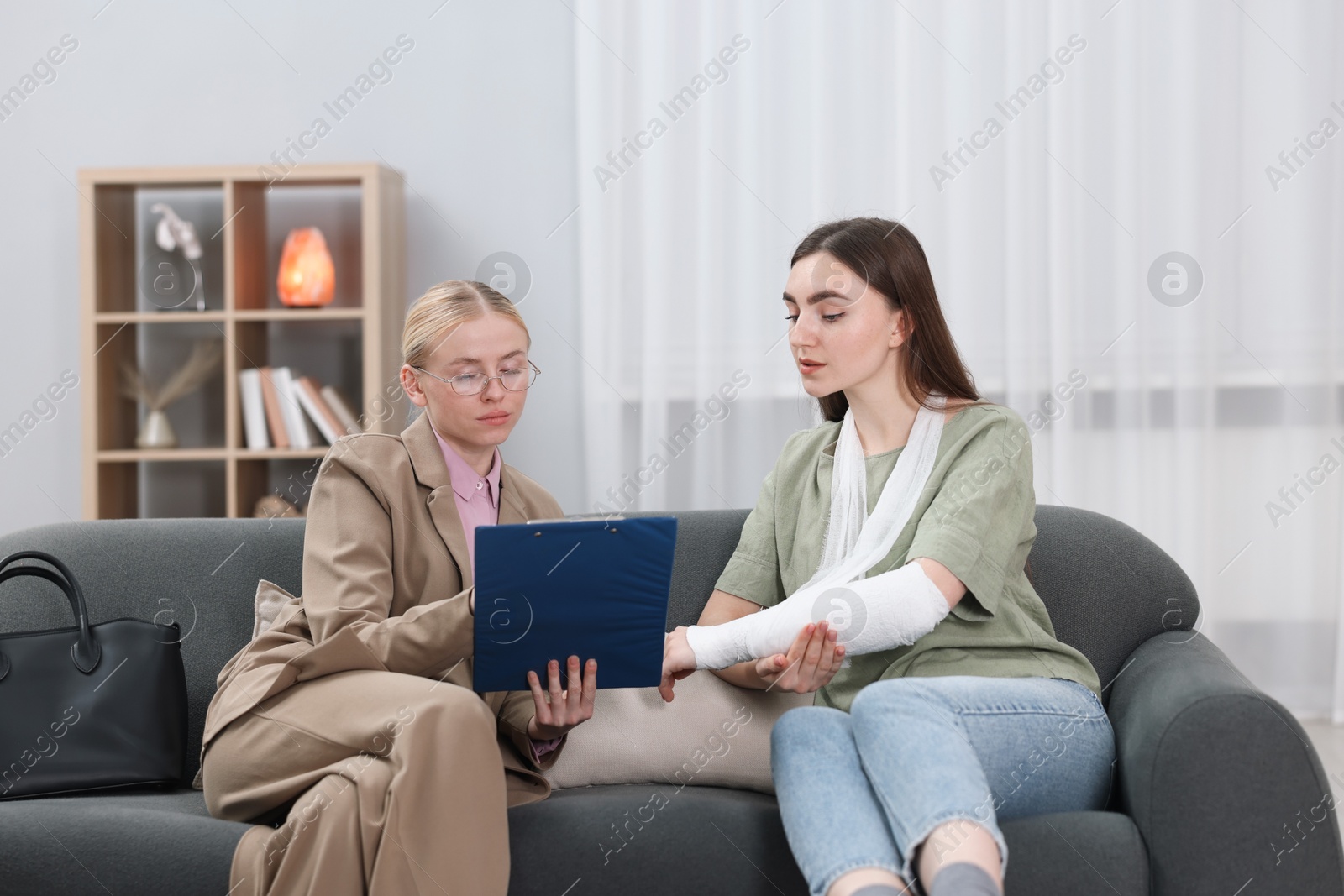 Photo of Injured woman having meeting with lawyer in office