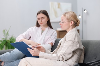 Photo of Injured woman having meeting with lawyer in office, selective focus