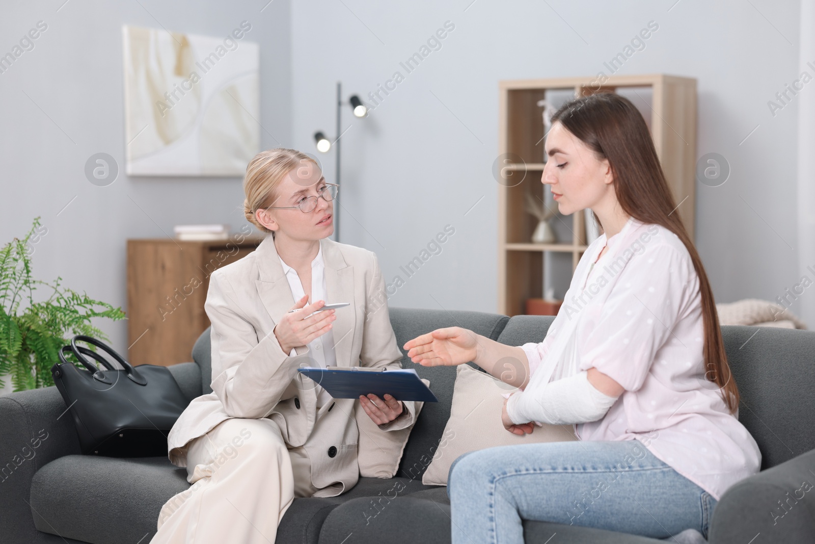 Photo of Injured woman having meeting with lawyer in office