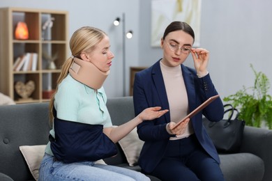 Photo of Injured woman having meeting with lawyer in office