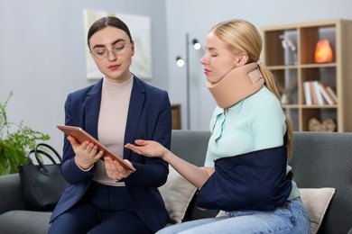 Photo of Injured woman having meeting with lawyer in office