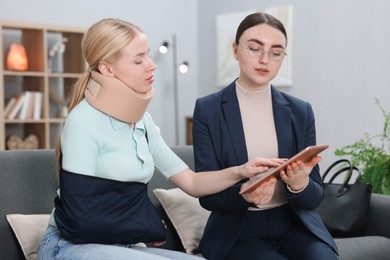 Photo of Injured woman having meeting with lawyer in office