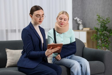 Photo of Injured woman having meeting with lawyer in office