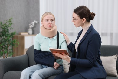 Injured woman having meeting with lawyer in office