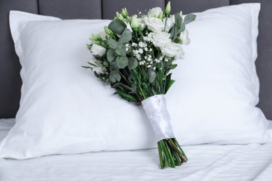 Photo of Wedding bouquet of beautiful flowers and pillow on bed