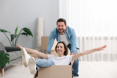 Photo of Moving day. Happy couple having fun in their new home