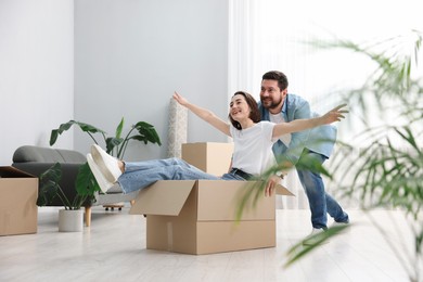 Photo of Moving day. Happy couple having fun in their new home