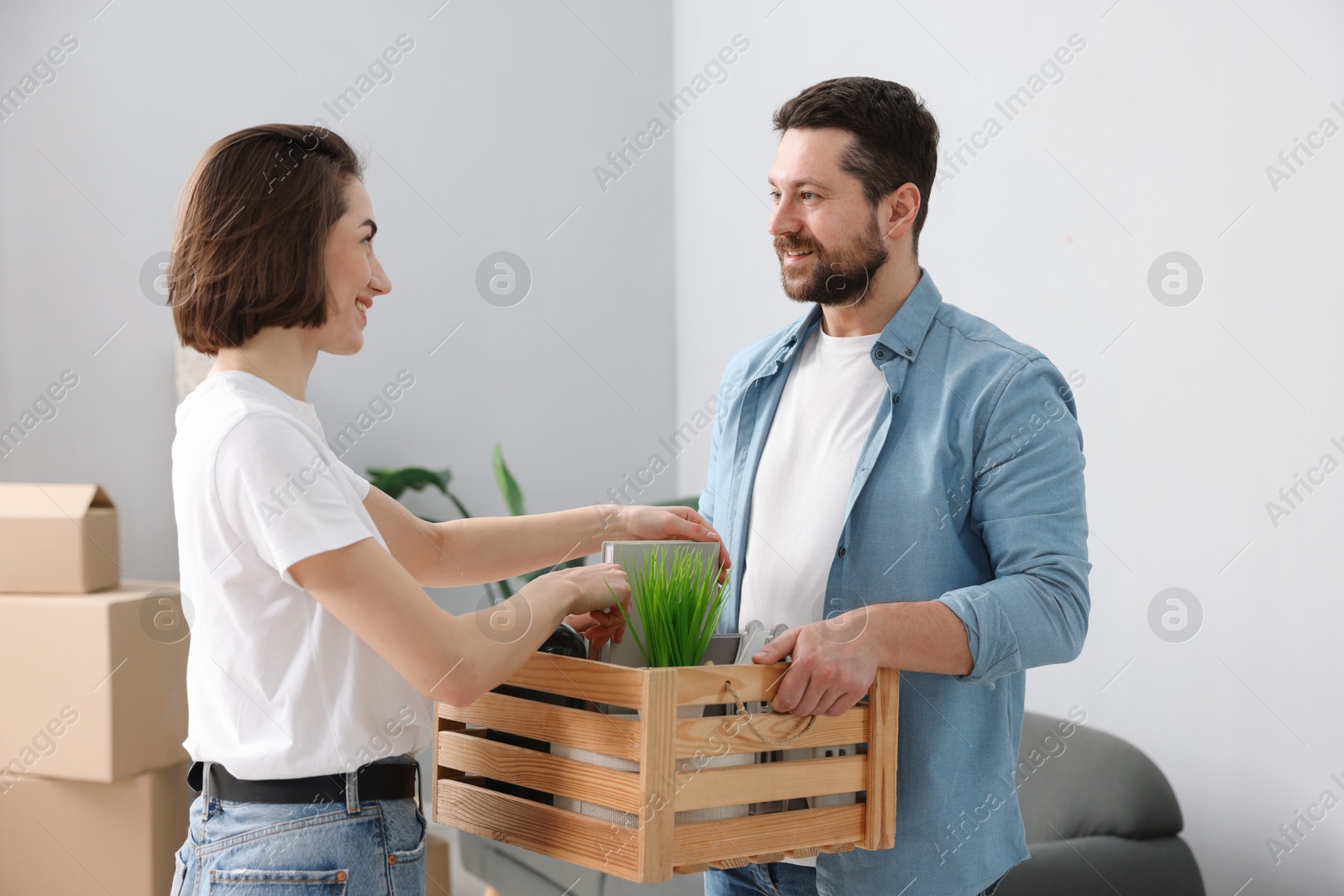 Photo of Moving day. Happy couple unpacking in their new home