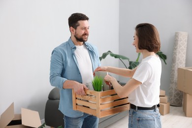 Photo of Moving day. Happy couple unpacking in their new home