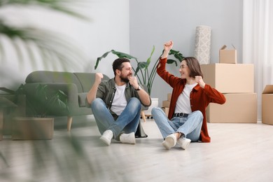 Photo of Moving day. Happy couple having fun in their new home